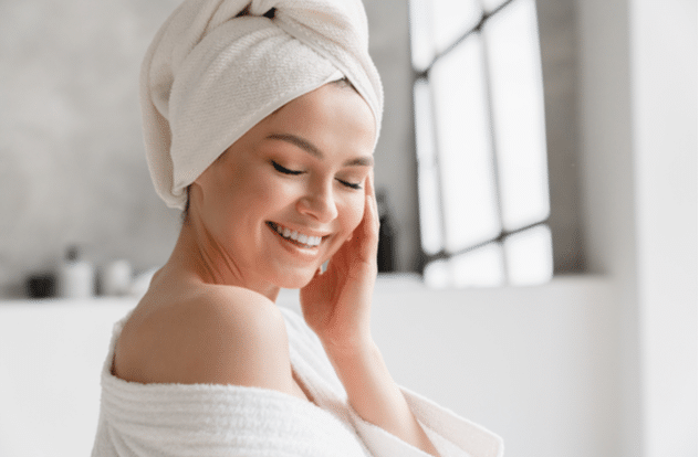 Calm serene young woman in bathrobe and towel relaxing after taking bath 0