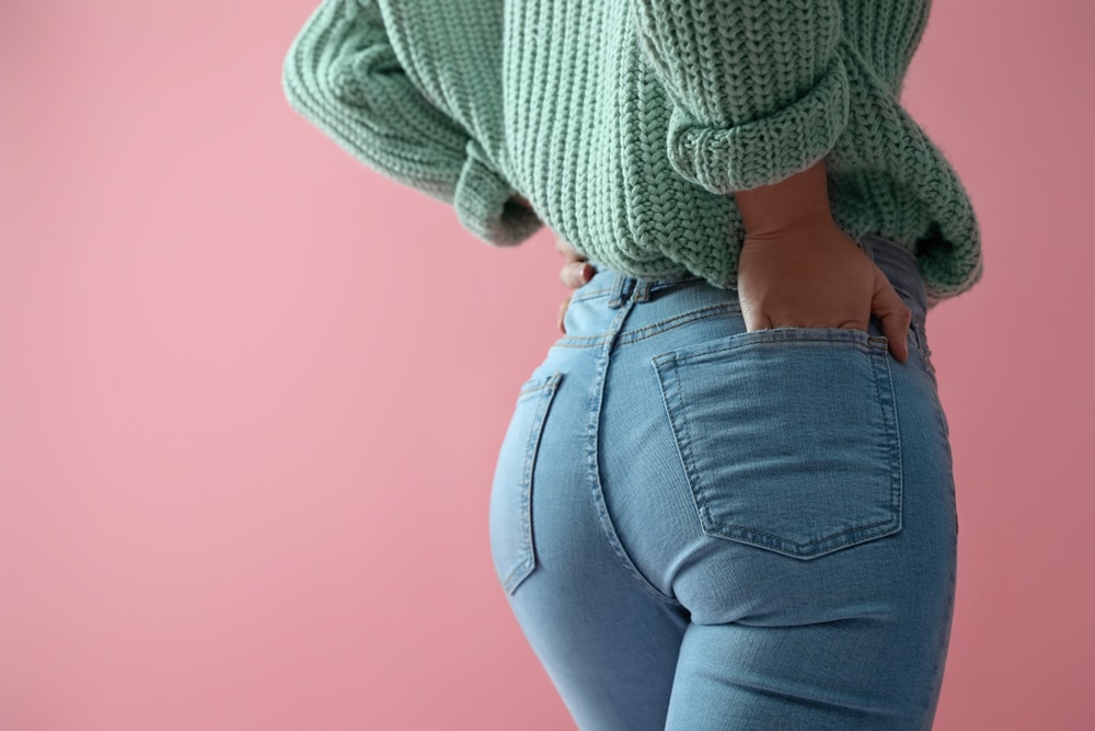 Woman,Wearing,Jeans,On,Pink,Background,,Closeup.,Space,For,Text