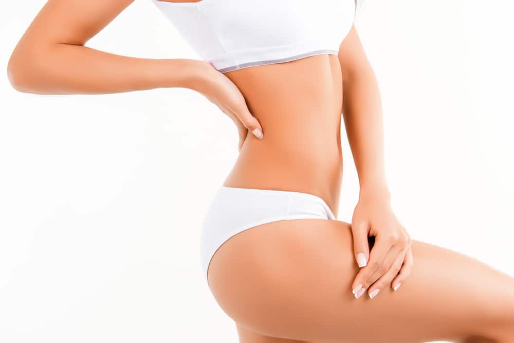 A cropped shot of a woman in white underwear showing smooth thighs from Aveli cellulite treatment