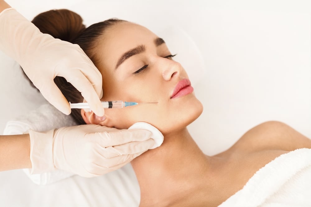 Relaxed woman getting facial dermal filler injections in Huntington Beach, CA