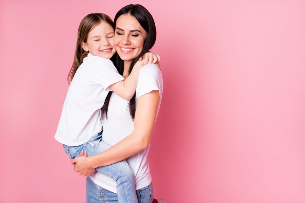 Mom holding her child after a mommy makeover in Huntington Beach, CA